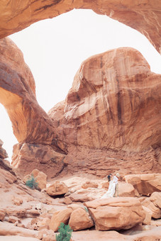 Wide shot of double arches with a wedding couple kissing
