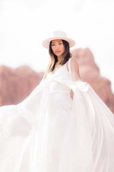 Bride playing with her wedding dress at arches national park