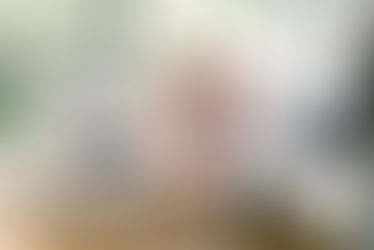 Family of four and a pug on their porch