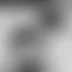 Elegant black and white wide shot of a couple walking hand-in-hand on a beach, framed by a luxury urban backdrop, embodying a high-fashion pre-wedding narrative.