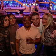 Guests socialising with cocktails at the bar