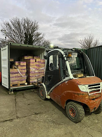 1. Forklift loading pallets into a storage container