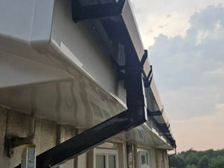 Close-up of white roof soffit and black guttering