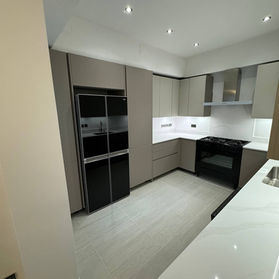 Contemporary grey fitted kitchen with integrated double oven