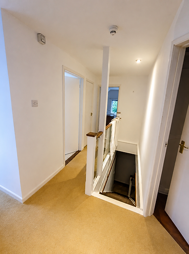 Upstairs hallway with white plastered walls