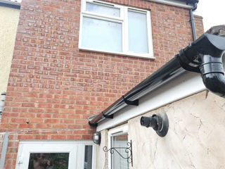 Red brick house exterior with white window and door