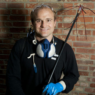 Chimney sweep professional wearing protective equipment