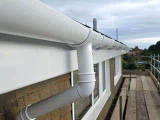 Close-up of white guttering installed on a house