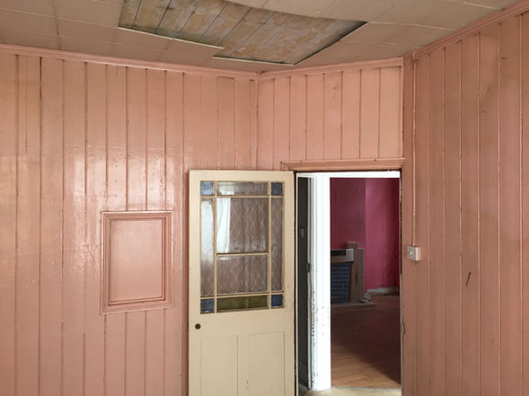 Wood panelled room with doorway and interior window