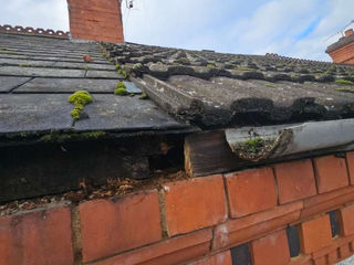 Slate roof with brick chimney and guttering