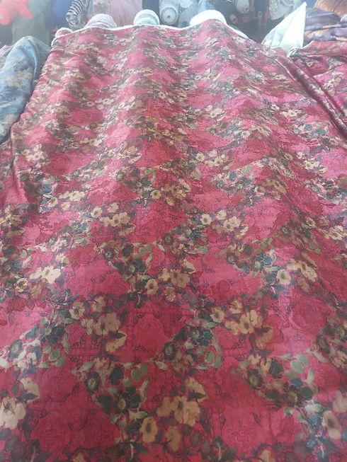 Pink fabric printed with dark floral patterns