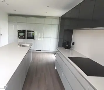 Contemporary galley kitchen with white worktops