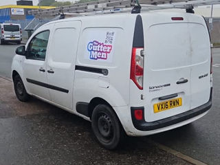 White Ford Transit van with logo in a parking lot