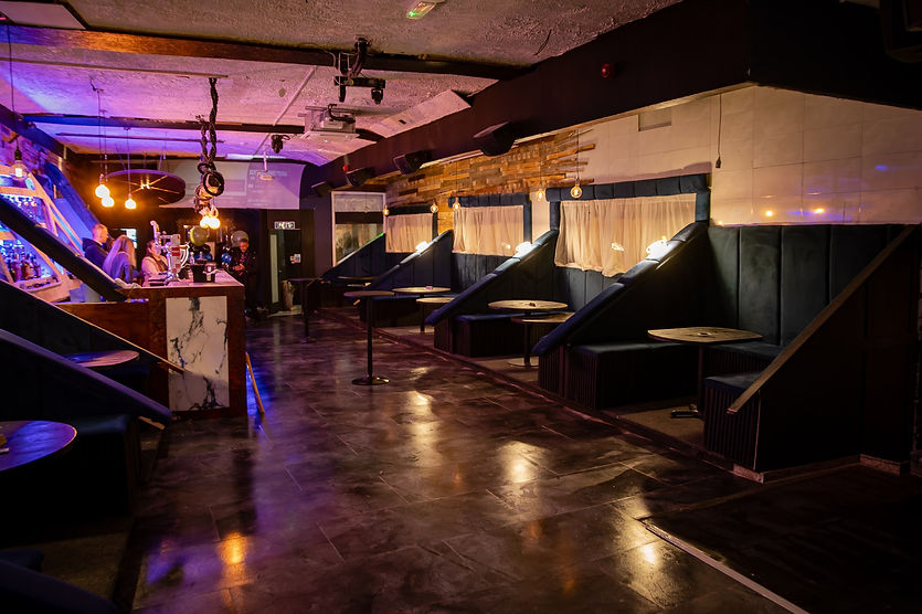 Modern cocktail bar with booth seating and ambient lighting in Preston