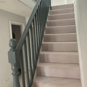 Refurbished residential staircase with fitted carpet and painted balustrade