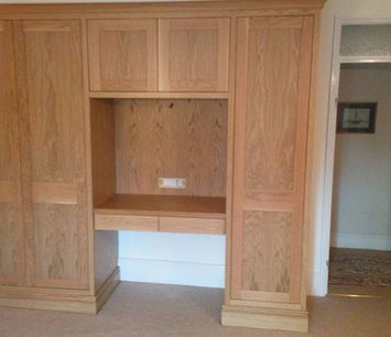 Oak fitted wardrobes with central dressing area