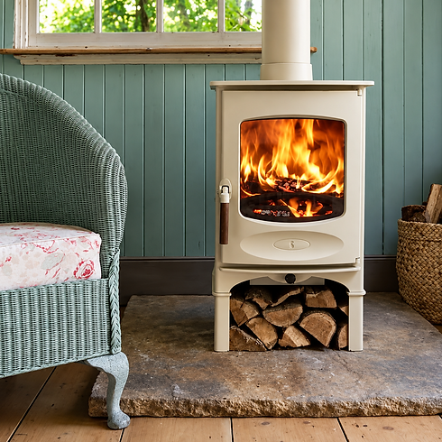 Cream wood burning stove with active fire burning inside
