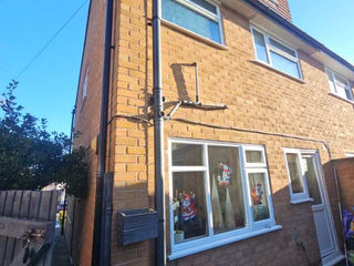 Three-story brick house with external pipe and windows