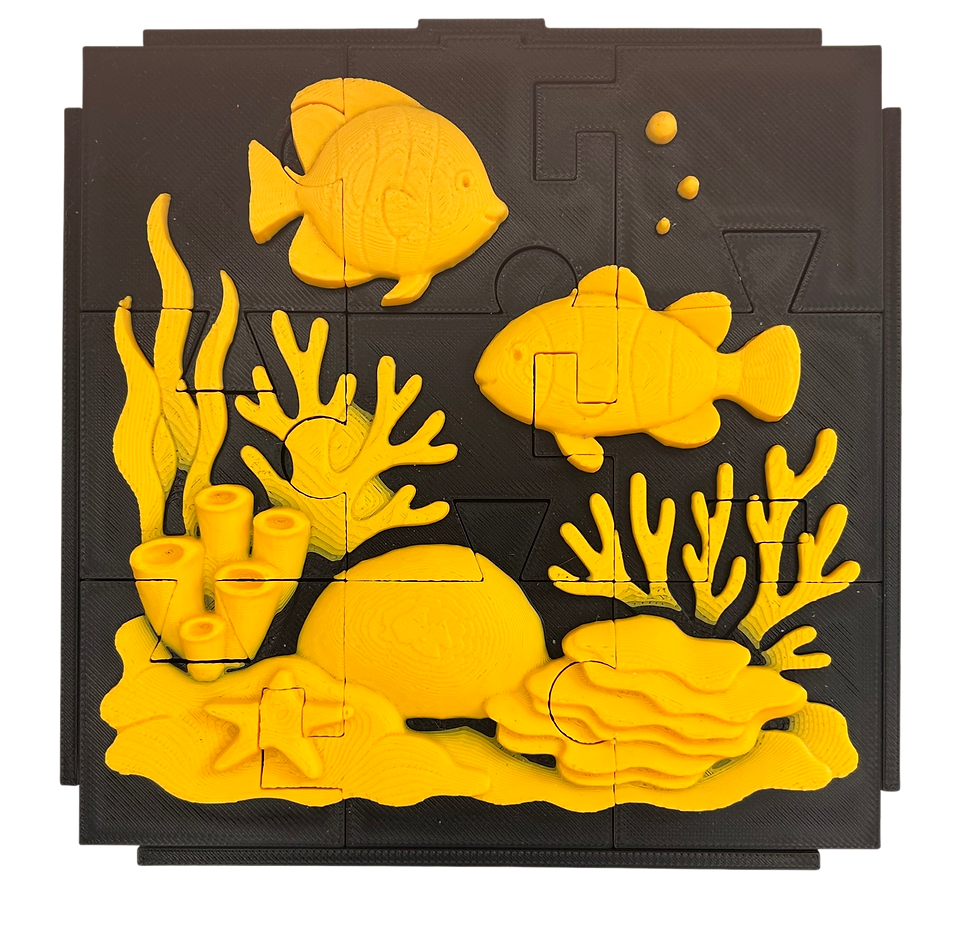 A completed relief tactile jigsaw puzzle of an underwater scene with two fish and a coral reef