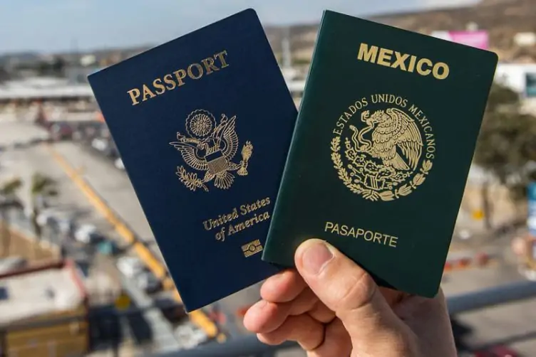 Hand holding US and Mexico passports; dual citizenship. Cozumel Immigration Consultant & More