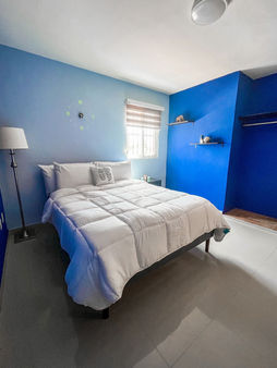 Bright bedroom in Terry’s House, this Cozumel house features a queen size bed with air conditioning.