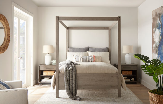 Bedroom scene of a grey poster bed