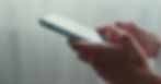 Close-up of hands holding a smartphone, symbolizing parental monitoring and tracking apps for teenagers