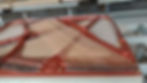 Close-up of the acrylic grand piano's rose-gold plate and strings