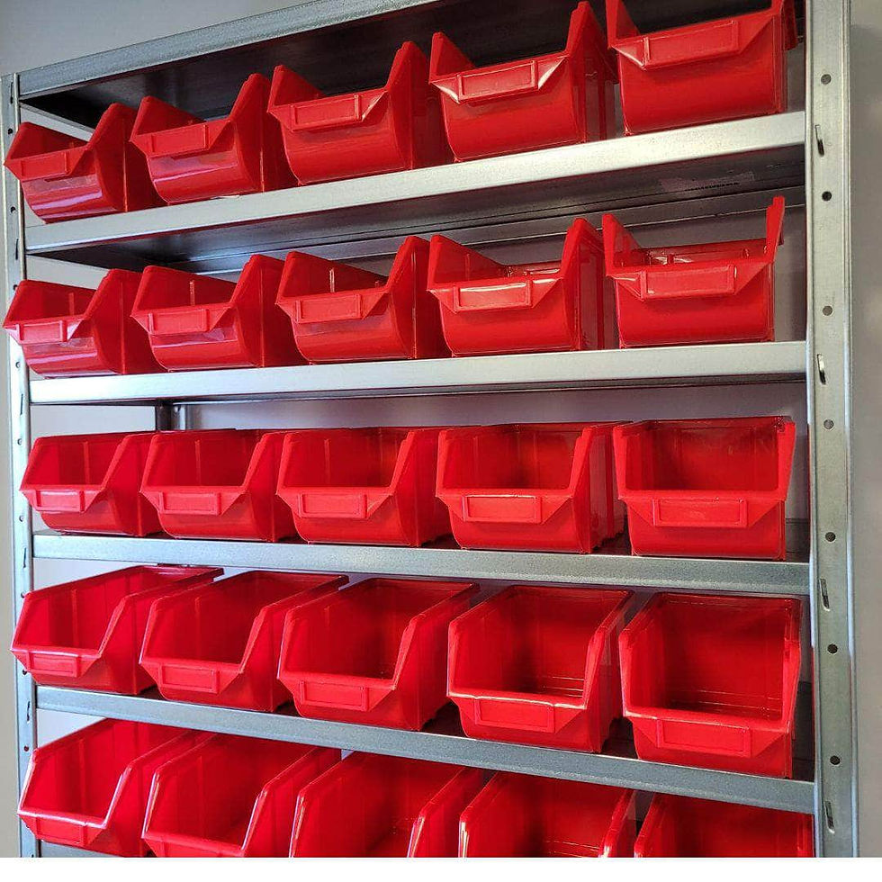 Red storage bins on metal shelving