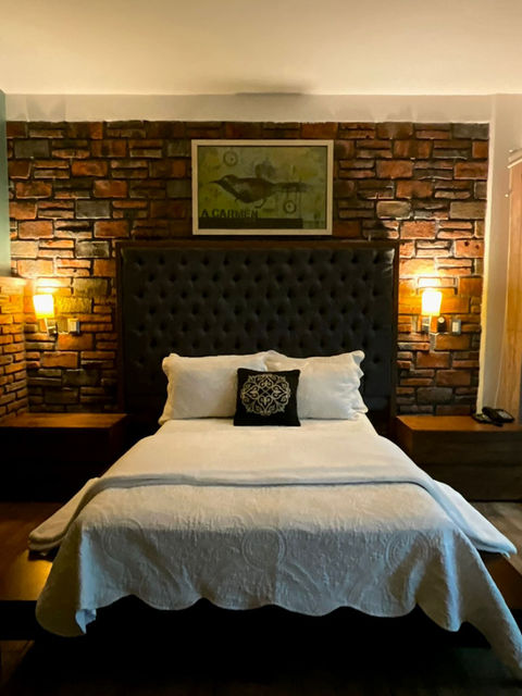 Cozy guest room in Querétaro with traditional Mexican decor and wooden furniture.

