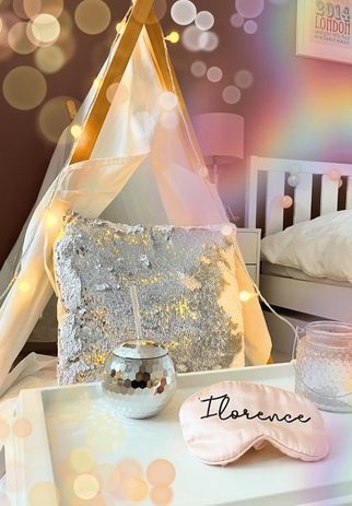 Teepee setup for a disco party, with shimmering decor, disco balls, and fairy lights