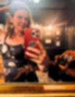 Karen Lane taking a selfie in a mirror, wearing jewellery