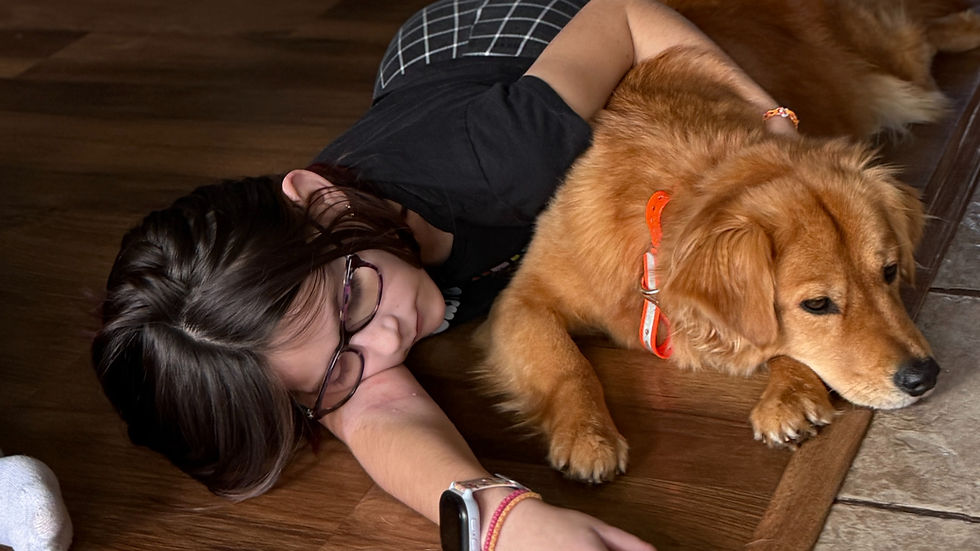 Golden retriever relaxing beside child in home-style dog boarding environment in Missoula, MT showing calm companionship and supervised care