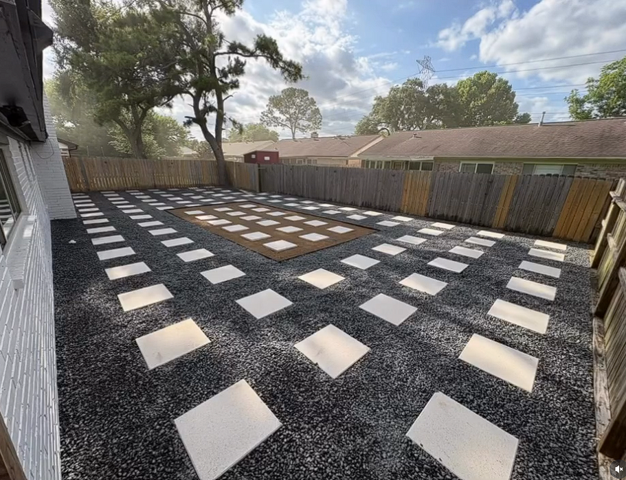 Completed backyard landscaping project by Landscaping Arts in Houston, Texas, featuring decorative stepping stones, gravel, and a professionally designed outdoor living space.