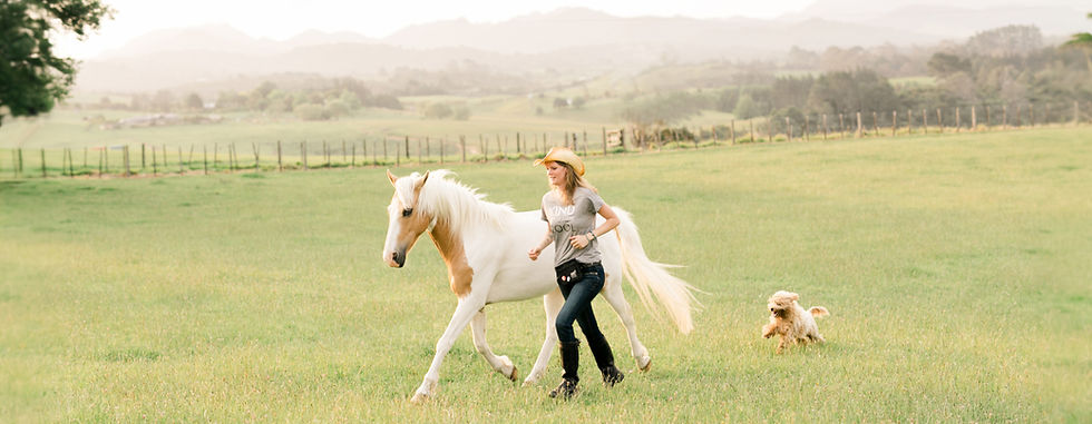 Bex Tasker founder of Positively Together with one of her horses and her dog