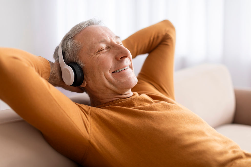 Relaxed Senior Man Enjoying Good Music At Home