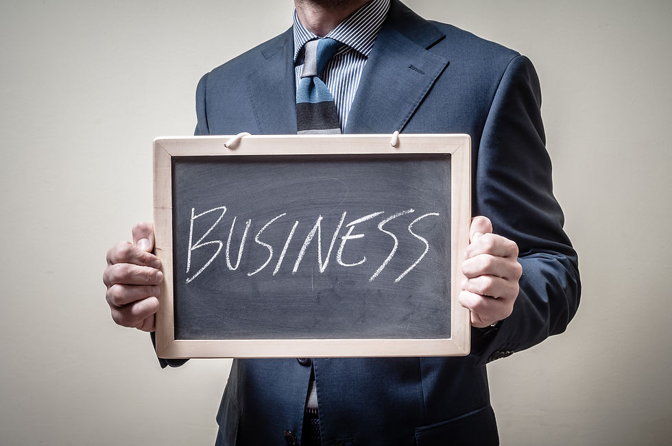 Businessman Holding Blackboard Written Business