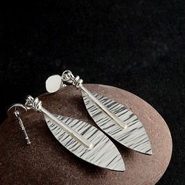 One of my most popular pieces.  These sterling silver leaves are heavily textured and given a gentle wave.  Hanging from simple, handmade silver studs (Or ear-wires if you'd prefer)