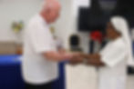 Br Tim Leen (an Aotearoa New Zealand–born Marist Brother) presenting a token of the Marist Brothers' appreciation to Sr Maria Goretti Leison