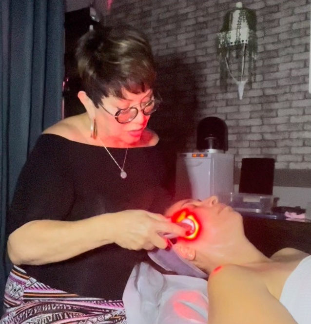 Brenda Oliver from The Loft Skin Studio applying light during facial in Modesto Ca
