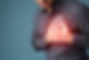 Young man pressing on chest with painful expression. Severe heartache, having heart attack