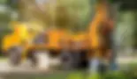Yellow drilling rig truck with a worker