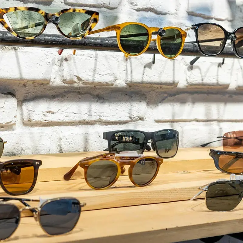 Collection of sunglasses displayed on shelves at Eye Q Optical