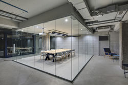 Luminous conference zone in the office in a loft style with brick walls and concrete columns.jpg
