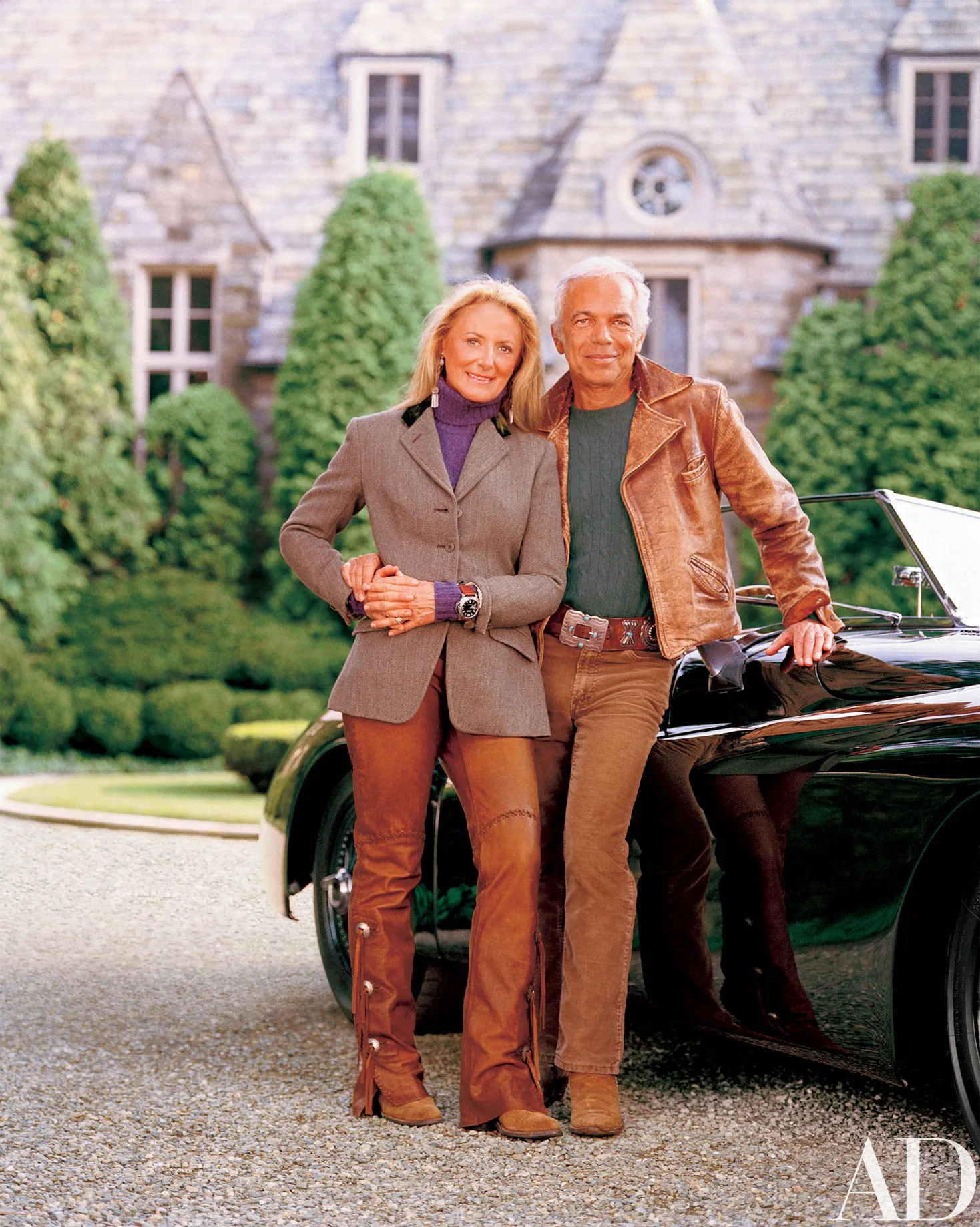 Ralph Lauren standing next to his luxury car in front of his mansion in Bedford, NY with his wife. Credit: AD