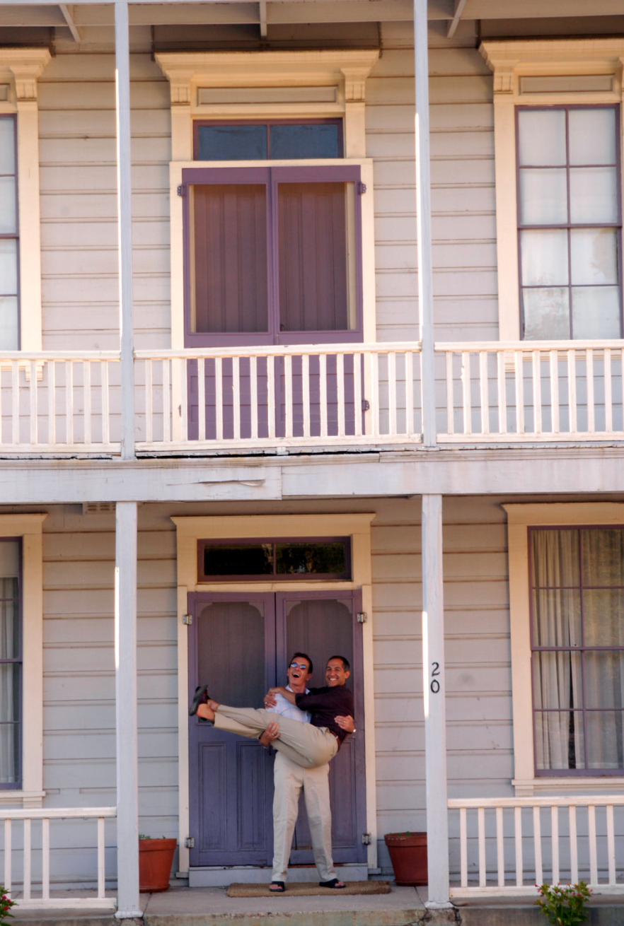 lgbtq couple celebrates on the threshold with a micro wedding and travels to guests later