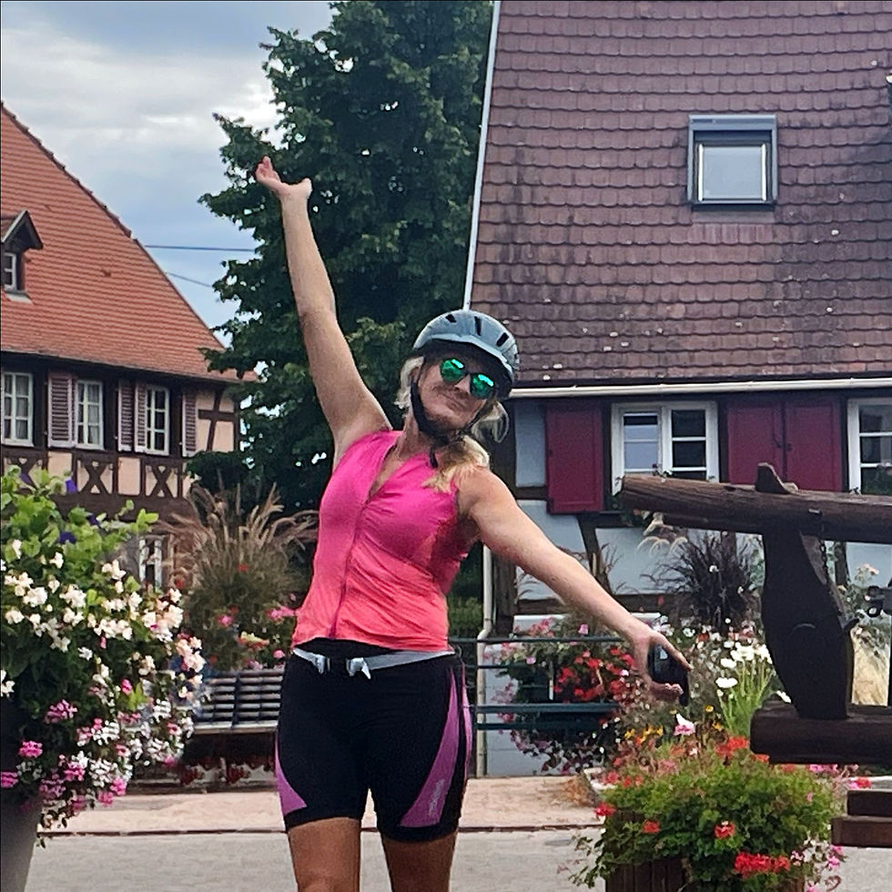 Cyclist celebrates a rest stop in Alsaces