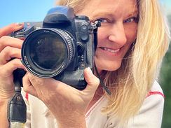 Jody Holman professional photographer peers from behind her lens