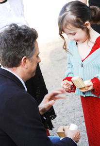 dad gives daughter a ring during a family wedding ceremony