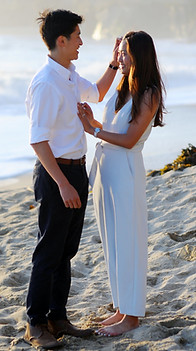 man tucks hair behind the ear of his soon to be fiancee prioo proposing marriage